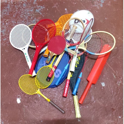 595 - A large assortment of rackets and bats.