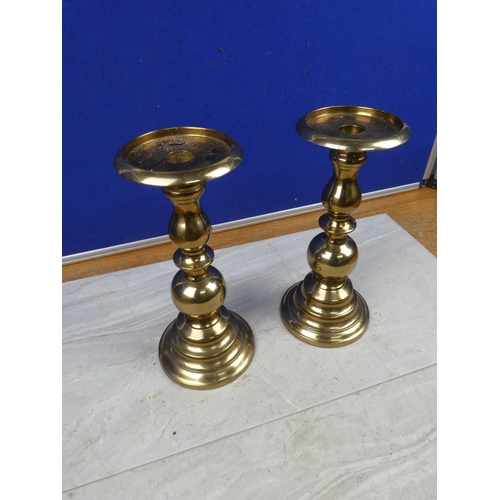 107 - A pair of brass candlesticks.