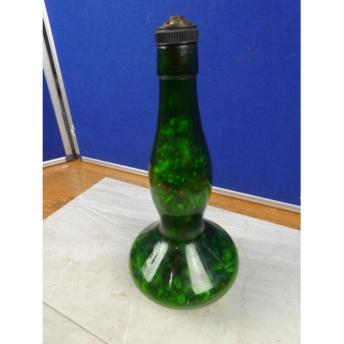 139 - A vintage green glass genie bottle containing a collection of marbles.