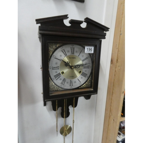 196 - A mahogany cased Acctim 31 day wall clock. Approx 48x24cm.