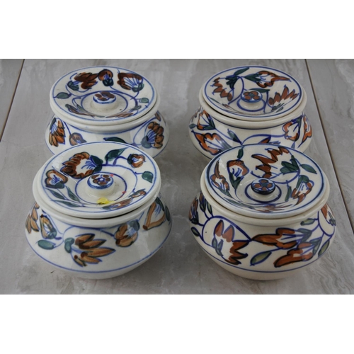 214 - Four lidded pottery spice pots.