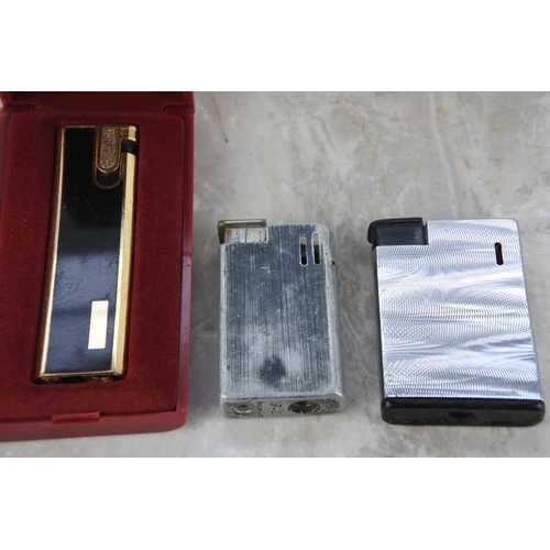 274 - A cased Kingsway Quartz Electric lighter and two others.