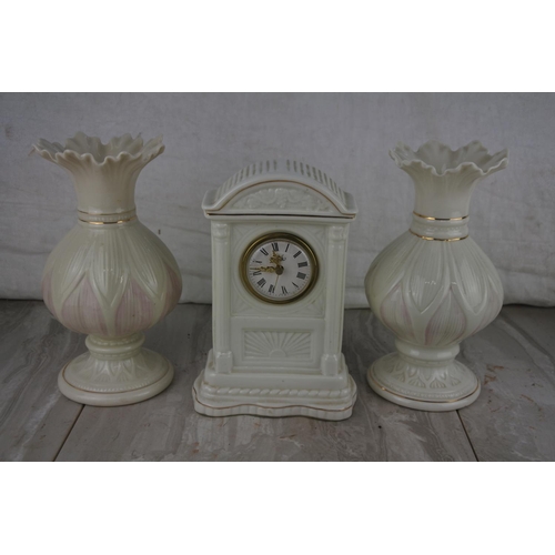33 - A pair of Belleek pottery vases and a Belleek mantle clock.