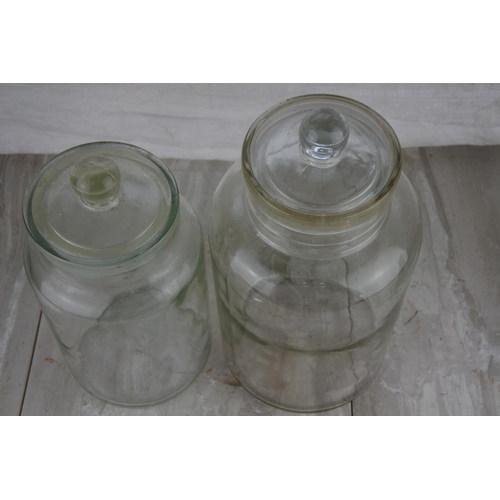 71 - Two large glass containers. Tallest approx 33cm.