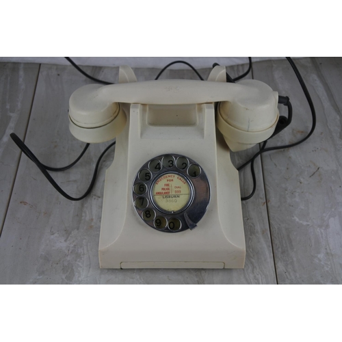 72 - A vintage cream rotary dial telephone.