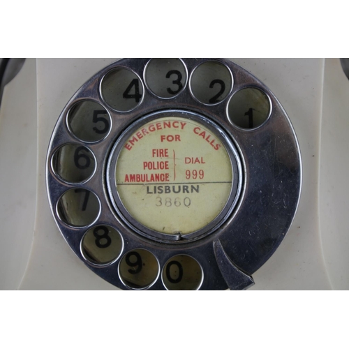 72 - A vintage cream rotary dial telephone.