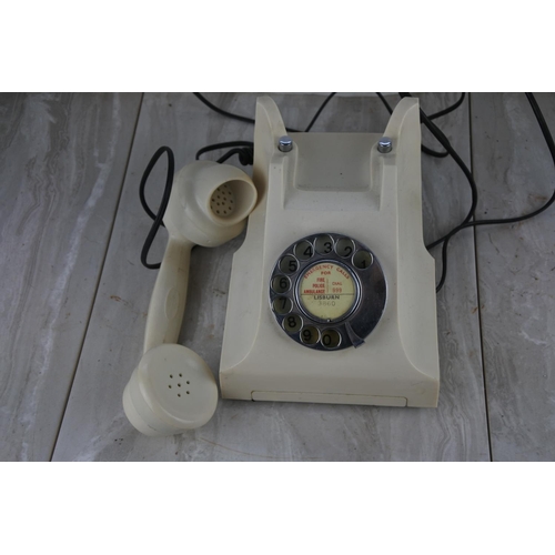 72 - A vintage cream rotary dial telephone.