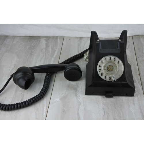 75 - A vintage black rotary dial telephone.