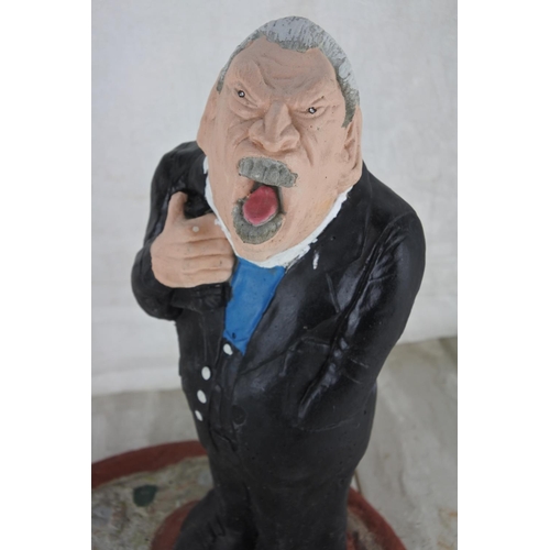 77 - A concrete garden figure of the Rev. Ian Paisley. Approx 34cm.