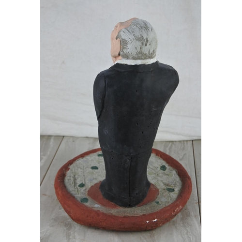 77 - A concrete garden figure of the Rev. Ian Paisley. Approx 34cm.