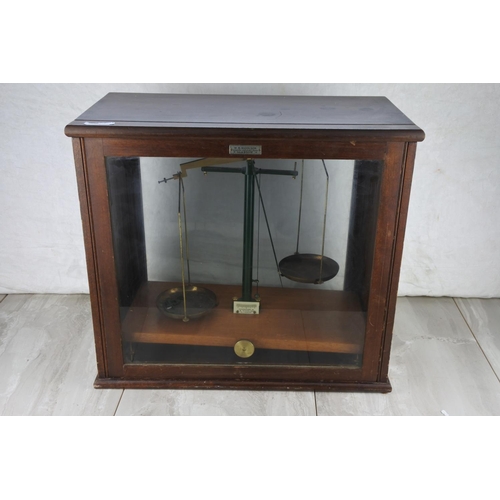 78 - A mahogany cased set of weighing scales by W B Nicolson, Glasgow. Approx 42x45x24cm.