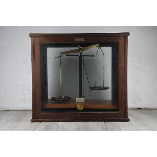 78 - A mahogany cased set of weighing scales by W B Nicolson, Glasgow. Approx 42x45x24cm.