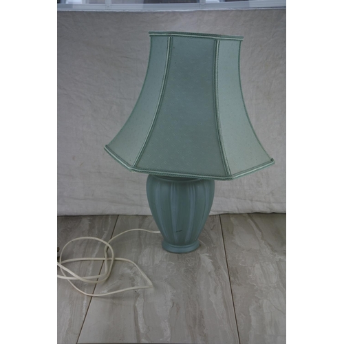 82 - A ceramic based table lamp and shade. Approx 55cm.