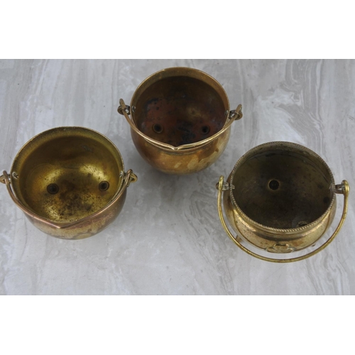 84 - Three small brass cauldrons.