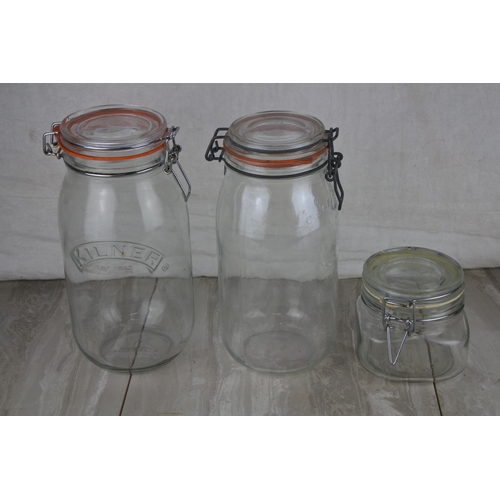 89 - Three glass storage jars.