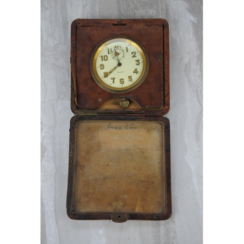 96 - A vintage leather cased 8 days travel clock.