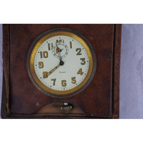 96 - A vintage leather cased 8 days travel clock.