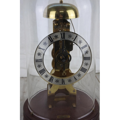 280 - A vintage skeleton mantle clock under a glass dome.  Approx 29cm.