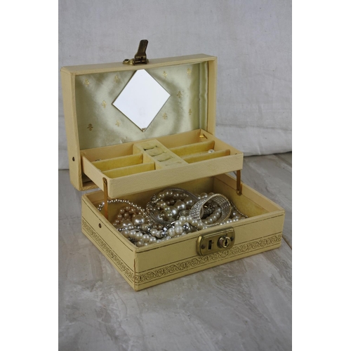 597 - A vintage jewellery box and contents,