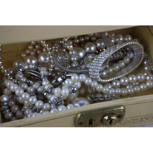 597 - A vintage jewellery box and contents,