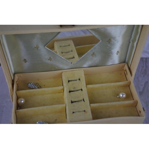 597 - A vintage jewellery box and contents,