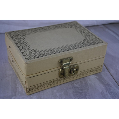 597 - A vintage jewellery box and contents,