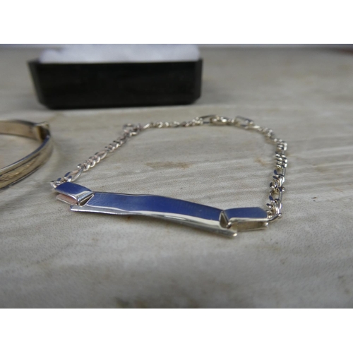 637 - A sterling silver child's bangle and a sterling silver identity bracelet.