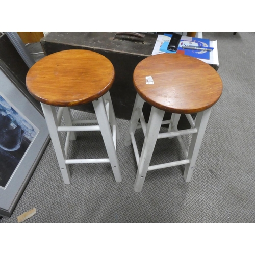 672 - A pair of circular topped wooden stools.