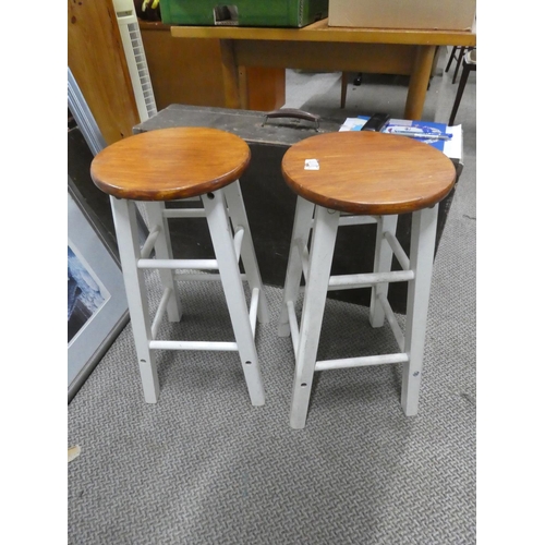 672 - A pair of circular topped wooden stools.