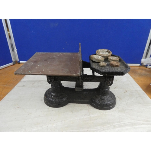 674 - A set of cast iron scales and weights.