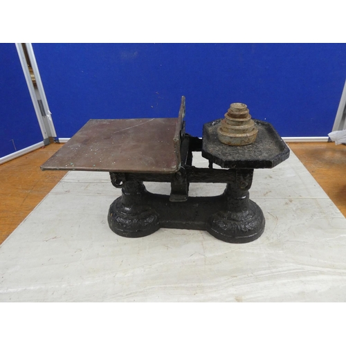 674 - A set of cast iron scales and weights.