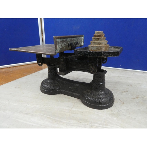 674 - A set of cast iron scales and weights.