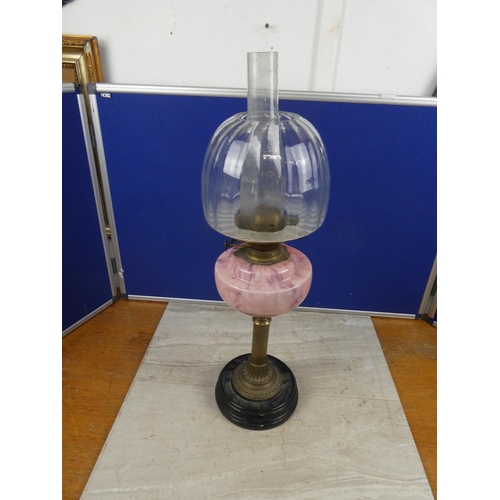 683 - A stunning antique oil lamp with pink marble font and clear glass shade.