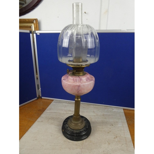 683 - A stunning antique oil lamp with pink marble font and clear glass shade.