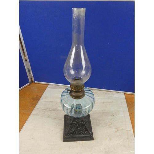 684 - An antique cottage oil lamp with blue glass font.