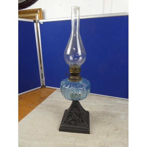 684 - An antique cottage oil lamp with blue glass font.