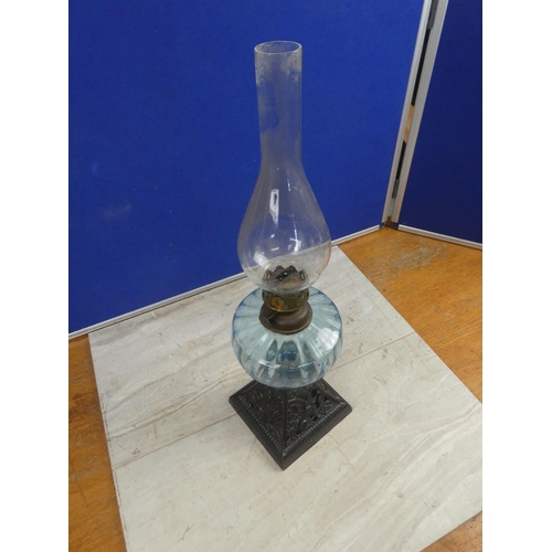 684 - An antique cottage oil lamp with blue glass font.