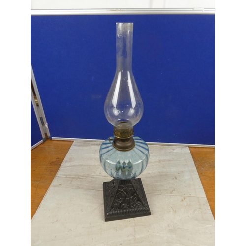 684 - An antique cottage oil lamp with blue glass font.