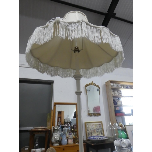 690 - An antique style standard lamp base and shade.