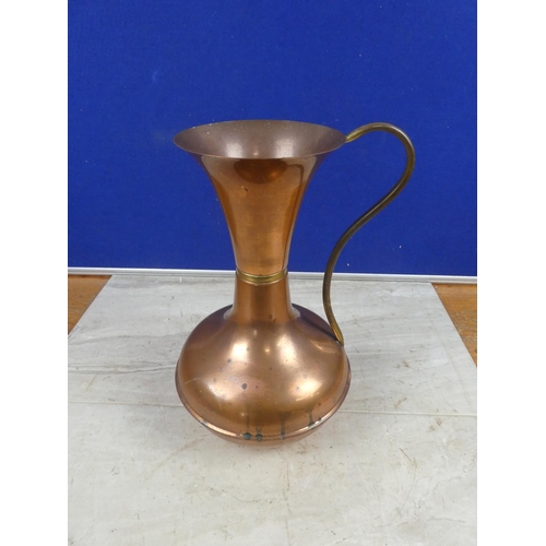 691 - A vintage copper jug.