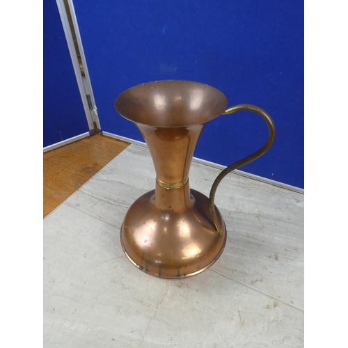 691 - A vintage copper jug.