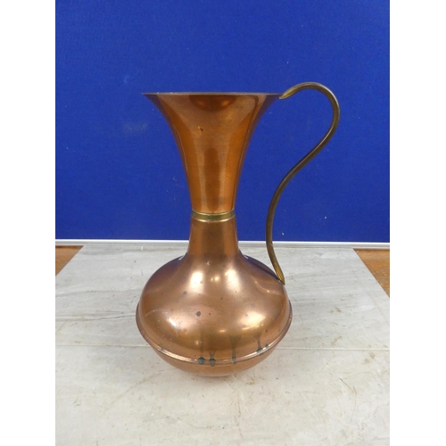 691 - A vintage copper jug.