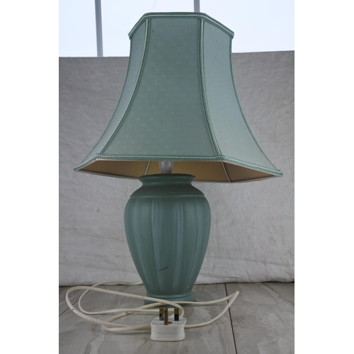 82 - A ceramic based table lamp and shade. Approx 55cm.
