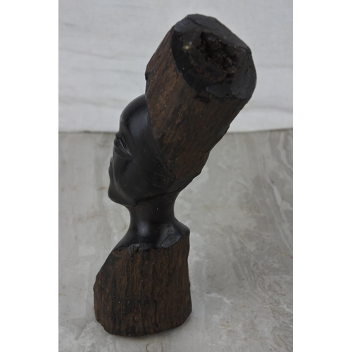 221 - A carved wooden African head. Approx 22cm.