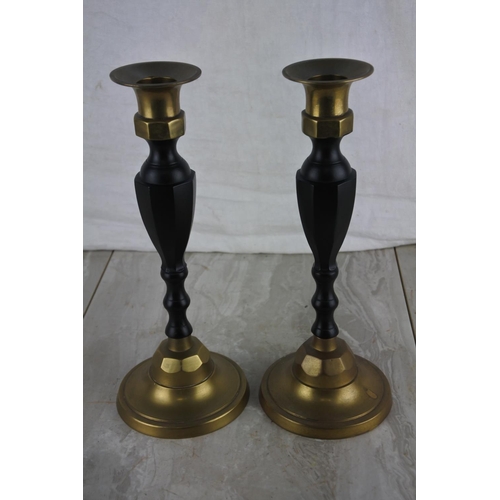 281 - A pair of brass and metal candlesticks.