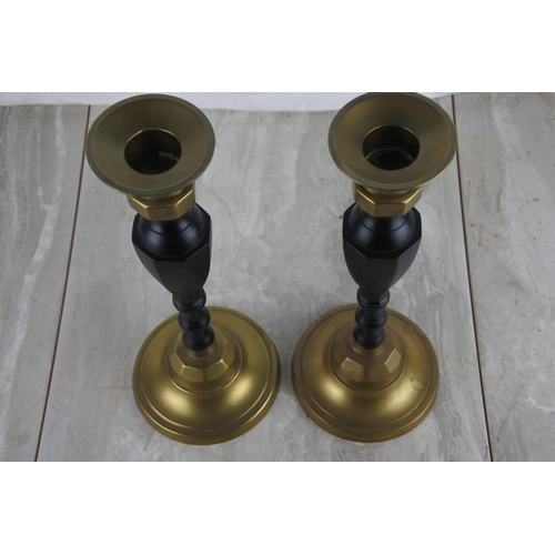 281 - A pair of brass and metal candlesticks.