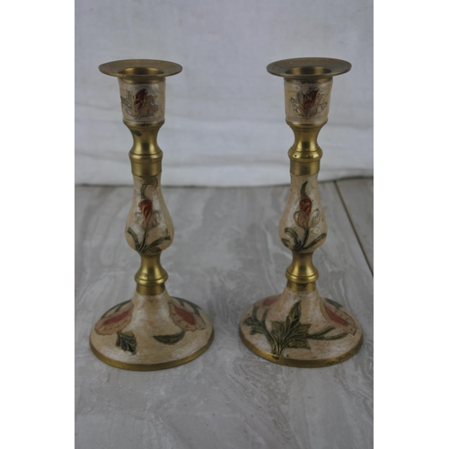 312 - A pair of Indian brass decorated candlesticks.