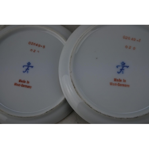 370 - Two small West German pottery plates decorated with birds.