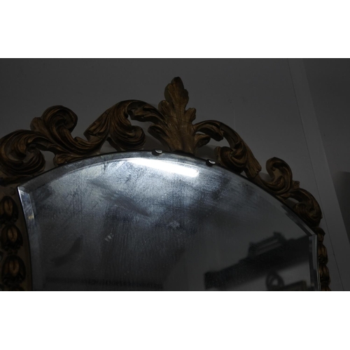 515 - A stunning gilt framed wall mirror with scroll detail. Approx 45x85CM.