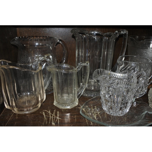 585 - A large collection of glass jugs and more.